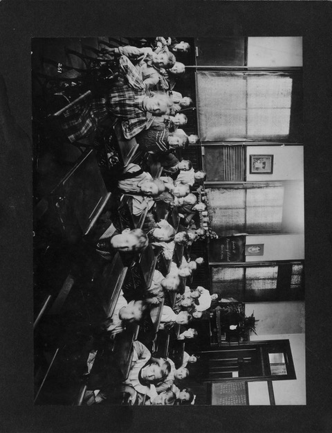 Students at their desks in an early classroom